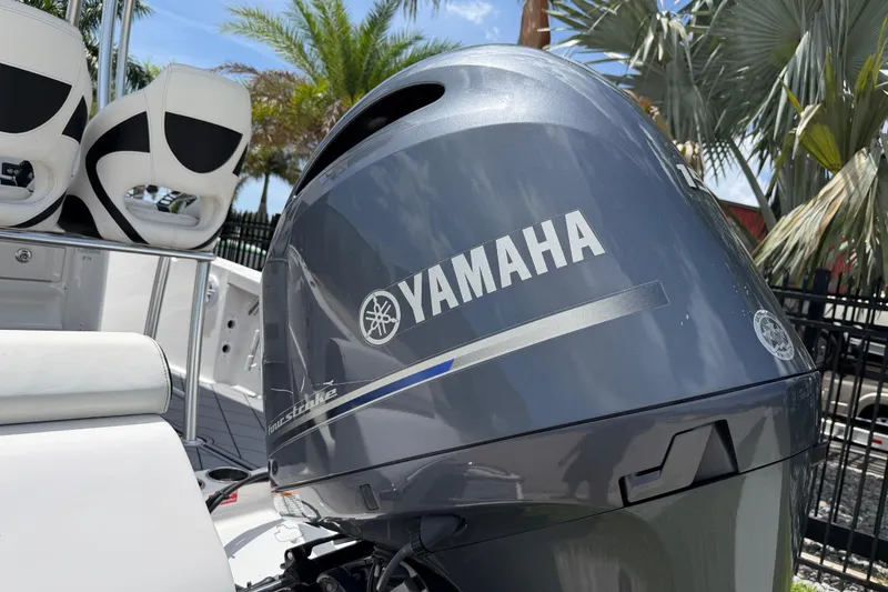 Slide: The Image of 2023 Tidewater 198 CC Adventure boat with Yamaha outboard motor, palm trees in background. - 5