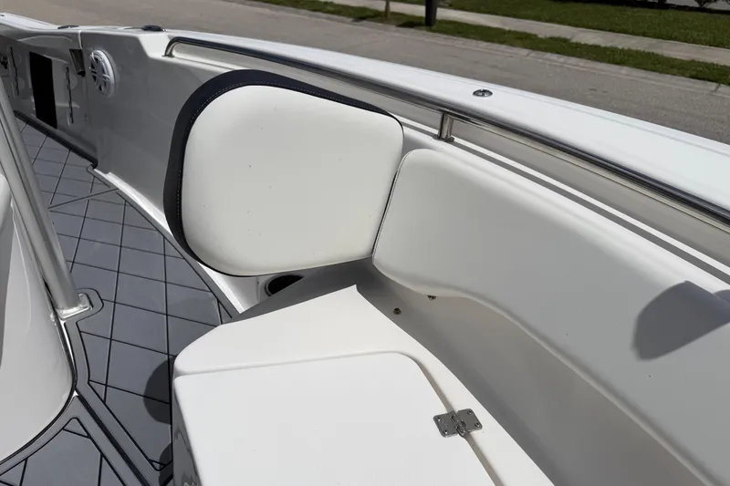 Slide: The Image of 2023 Tidewater 198 CC Adventure boat interior with cushioned seating and stainless steel railing. - 56