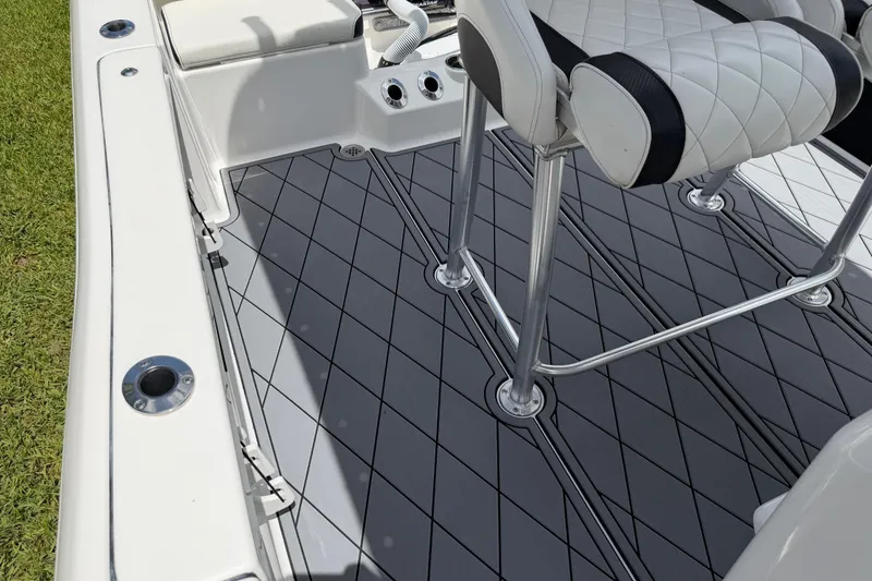 Slide: The Image of 2023 Tidewater 198 CC Adventure boat interior with cushioned seating and non-slip flooring. - 74