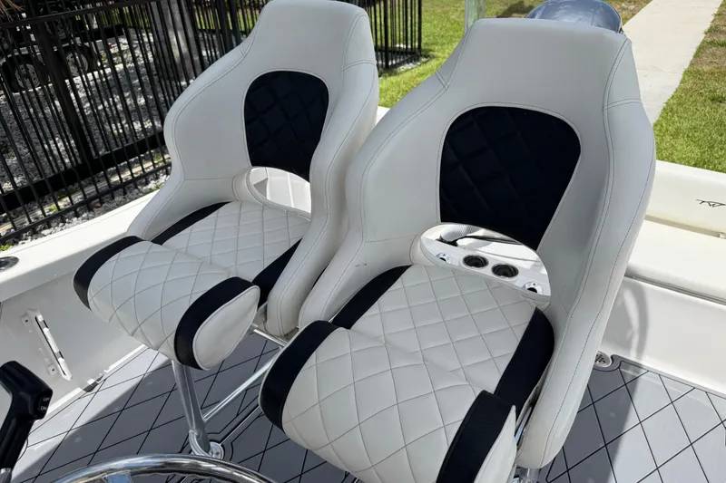 Slide: The Image of 2023 Tidewater 198 CC Adventure boat seats with quilted white and black design. - 75