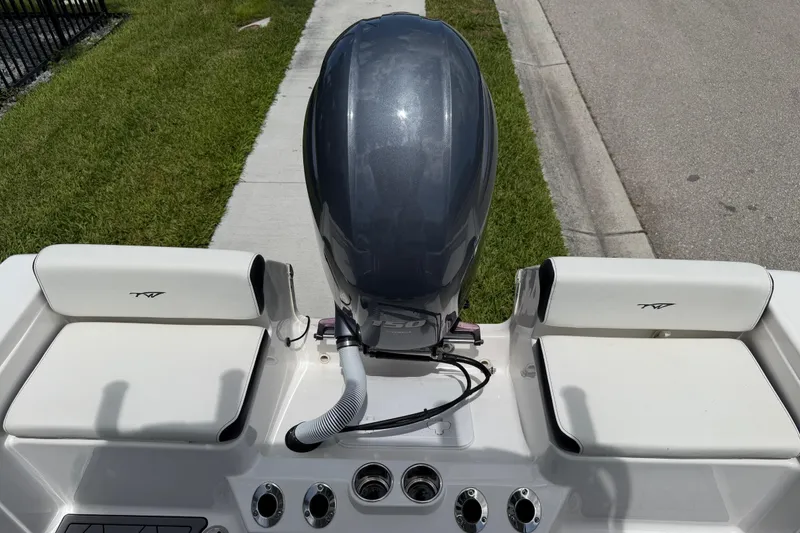Slide: The Image of 2023 Tidewater 198 CC Adventure boat with outboard motor and cushioned seating. - 79