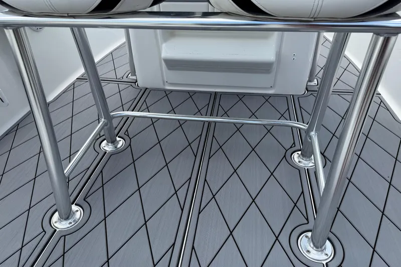 Slide: The Image of 2023 Tidewater 198 CC Adventure boat deck with sleek metal railings and patterned flooring. - 84