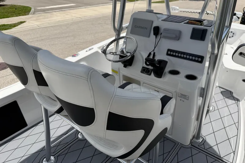 Slide: The Image of 2023 Tidewater 198 CC Adventure boat interior with dual seats and modern console. - 87