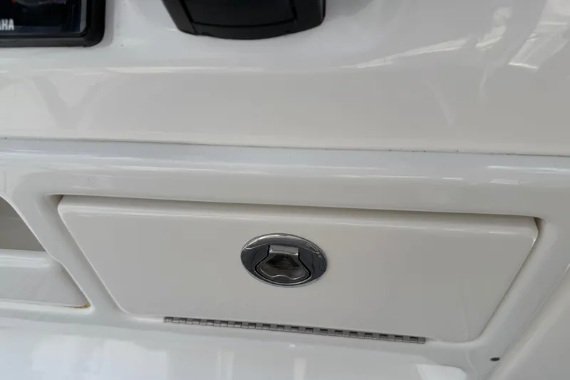 Slide: The Image of Close-up of 2023 Tidewater 198 CC Adventure boat compartment with latch. - 91
