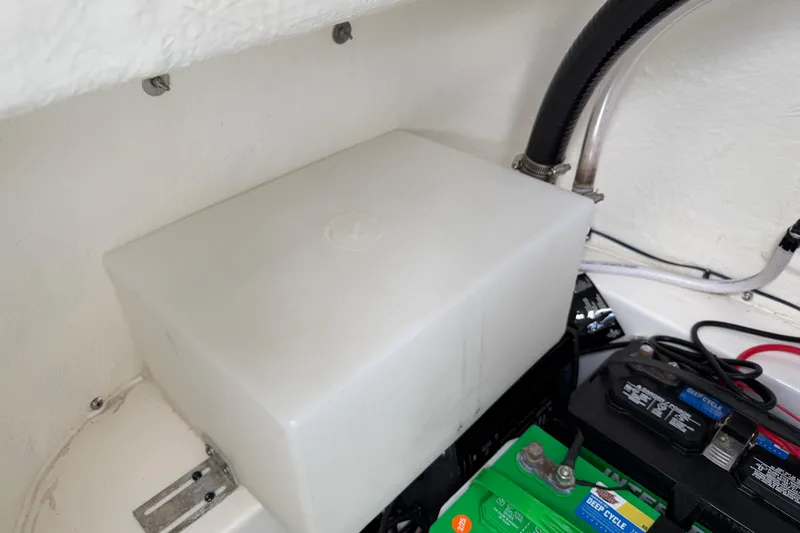 Slide: The Image of 2023 Tidewater 198 CC Adventure boat battery compartment with deep cycle battery and wiring. - 95
