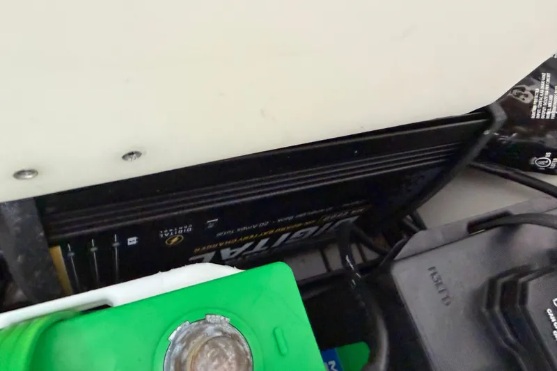 Slide: The Image of Battery compartment of 2023 Tidewater 198 CC Adventure boat, featuring marine equipment. - 96