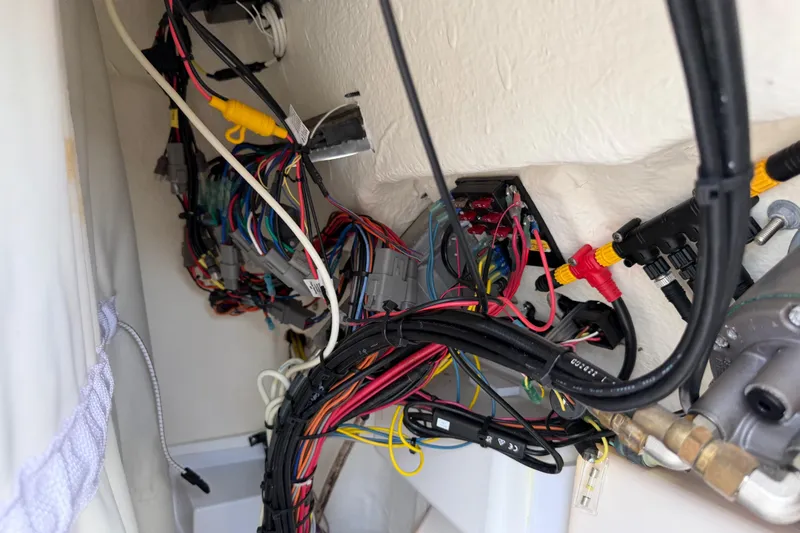 Slide: The Image of Wiring system inside 2023 Tidewater 198 CC Adventure boat, showcasing complex electrical connections. - 98
