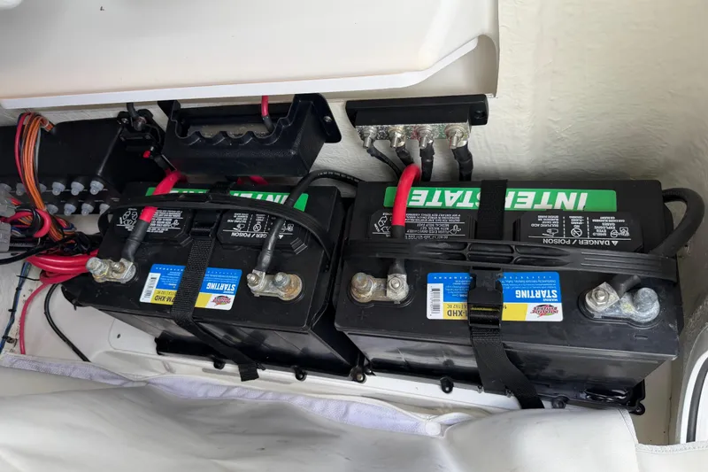 Slide: The Image of Dual Interstate batteries in a 2023 Tidewater 198 CC Adventure boat, securely installed. - 99