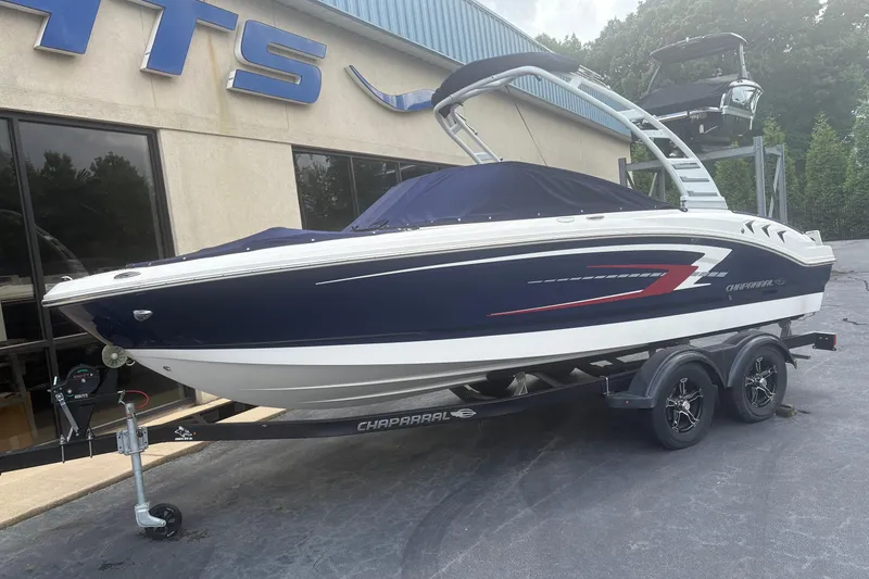 Slide: The Image of 2025 Chaparral 21 SSi boat on trailer, parked outside dealership. - 1