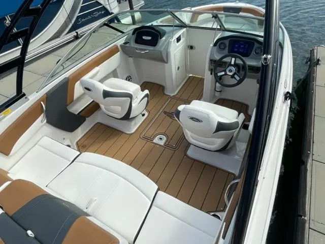 Slide: The Image of 2025 Chaparral 21 SSi boat interior with modern seating and dashboard. - 6