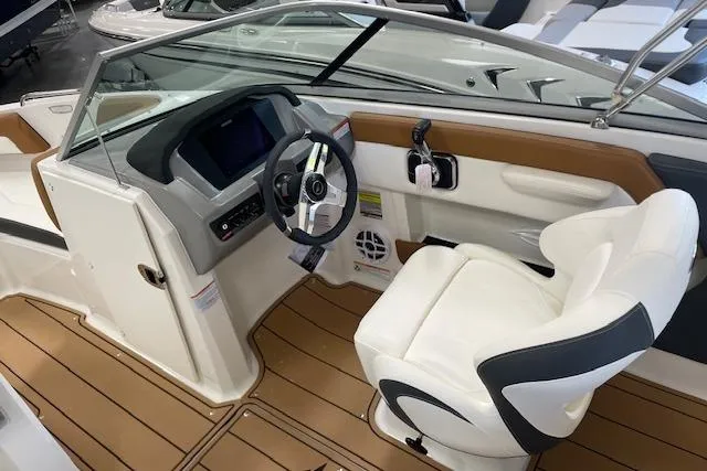 Slide: The Image of 2025 Chaparral 21 SSi boat interior with modern dashboard and white captain's chair. - 9