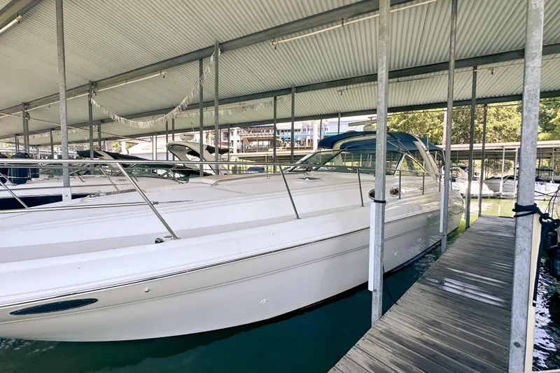 Slide: The Image of 2001 Sea Ray 410 Sundancer docked under a covered marina. - 1