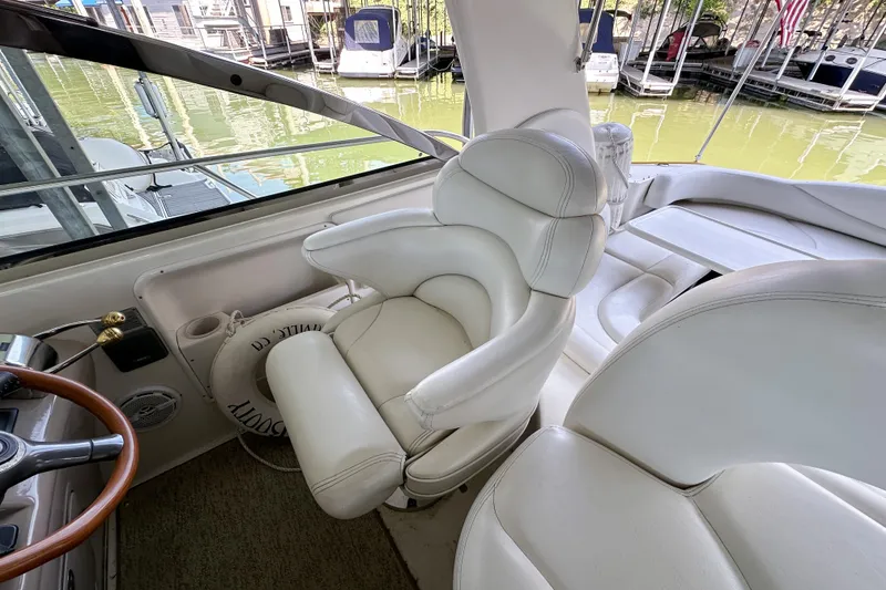 Slide: The Image of Interior of 2001 Sea Ray 410 Sundancer yacht with plush white seating. - 16