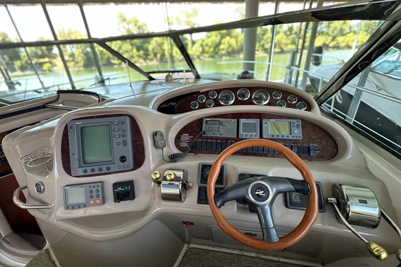 Slide: The Image of Cockpit of 2001 Sea Ray 410 Sundancer with navigation instruments and steering wheel. - 17
