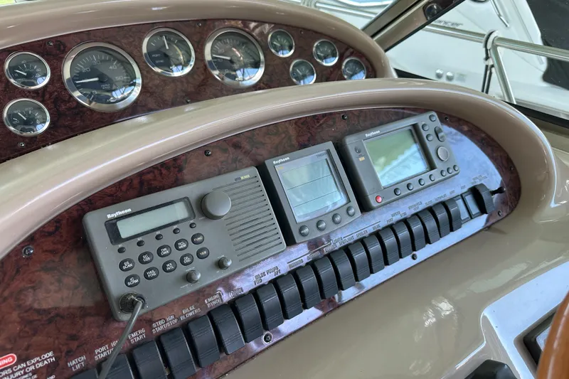 Slide: The Image of Dashboard of a 2001 Sea Ray 410 Sundancer with navigation instruments and gauges. - 18