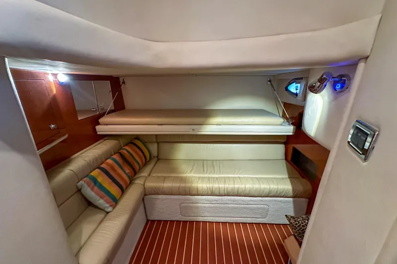 Slide: The Image of Interior of 2001 Sea Ray 410 Sundancer yacht with cozy seating and striped cushions. - 25