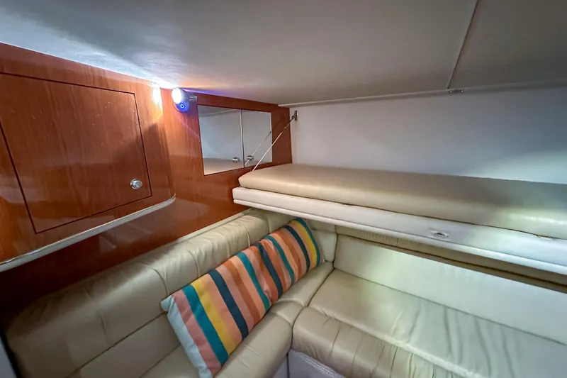 Slide: The Image of Luxurious interior of 2001 Sea Ray 410 Sundancer with leather seating and striped pillow. - 26