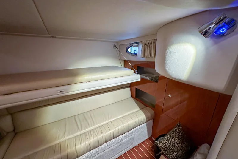 Slide: The Image of Interior cabin of 2001 Sea Ray 410 Sundancer with cozy seating and ambient lighting. - 27