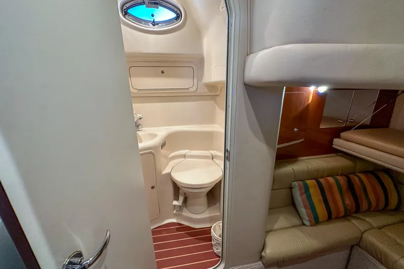 Slide: The Image of 2001 Sea Ray 410 Sundancer yacht interior with bathroom and cozy seating area. - 28