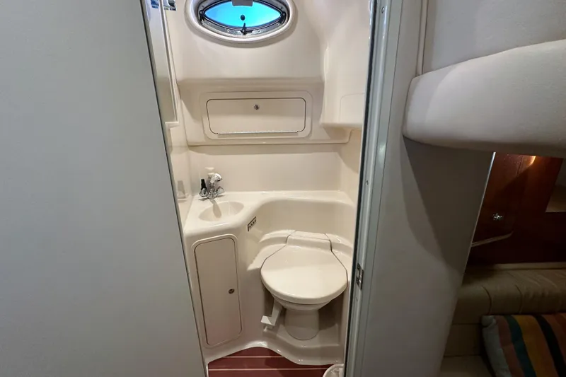 Slide: The Image of Compact bathroom in 2001 Sea Ray 410 Sundancer yacht, featuring toilet and sink. - 29