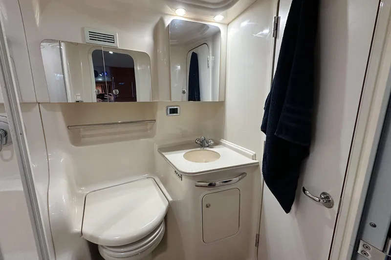 Slide: The Image of Bathroom interior of 2001 Sea Ray 410 Sundancer yacht, featuring sink and toilet. - 38