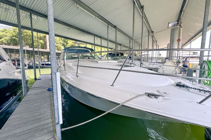 Slide: The Image of 2001 Sea Ray 410 Sundancer yacht docked under a covered marina. - 4