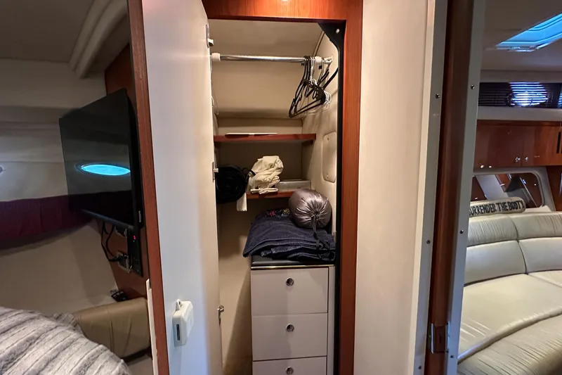 Slide: The Image of Interior of 2001 Sea Ray 410 Sundancer showing closet with hangers and storage. - 42