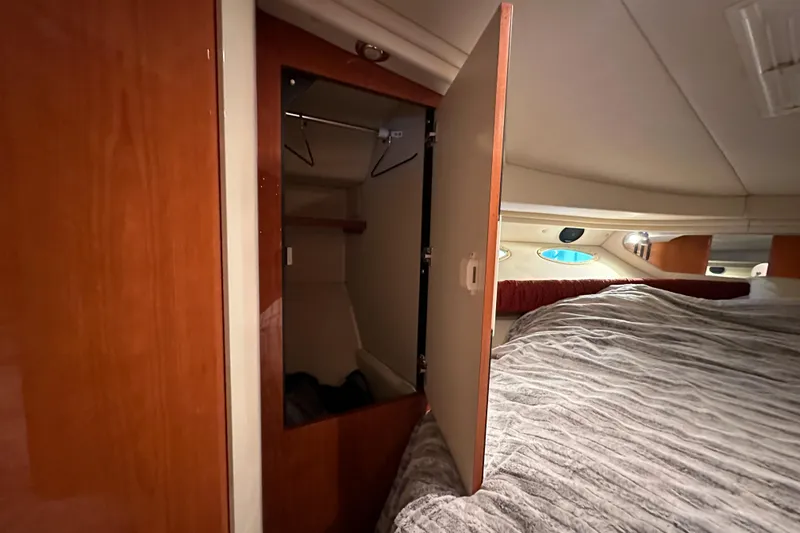 Slide: The Image of Interior cabin of 2001 Sea Ray 410 Sundancer with open closet and bed. - 43