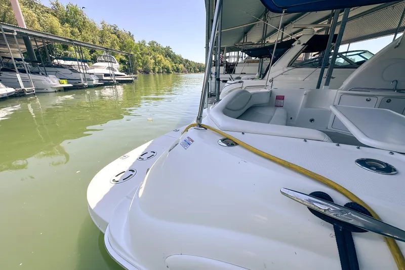 Slide: The Image of 2001 Sea Ray 410 Sundancer docked at a marina with lush greenery. - 5