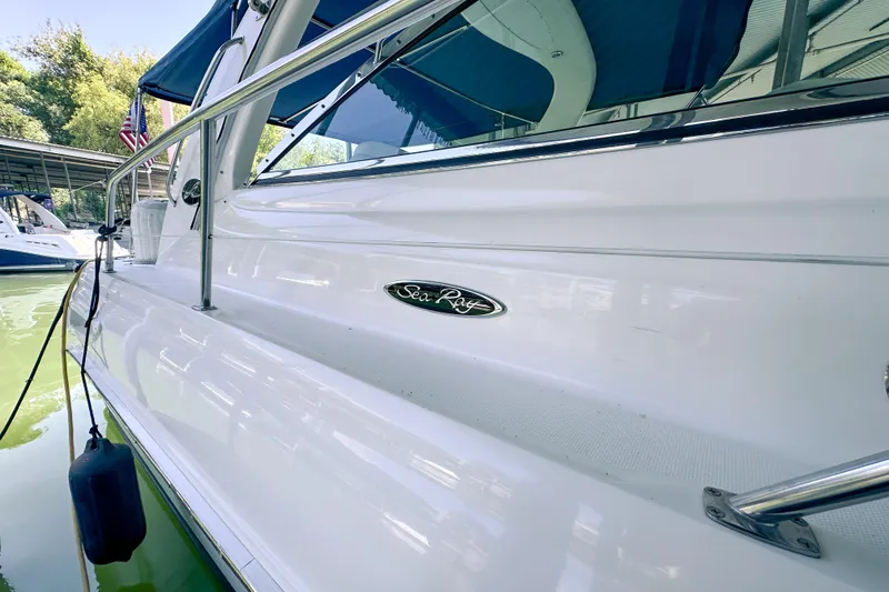 Slide: The Image of 2001 Sea Ray 410 Sundancer yacht docked, showcasing sleek white exterior and logo. - 6