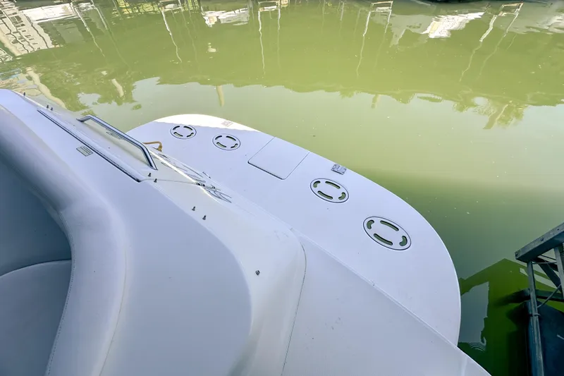 Slide: The Image of 2001 Sea Ray 410 Sundancer boat deck by calm water. - 7