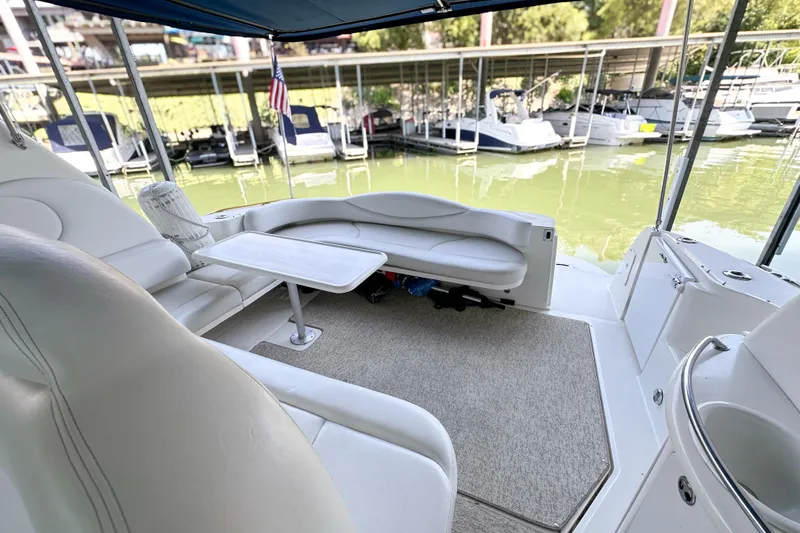 Slide: The Image of Interior of 2001 Sea Ray 410 Sundancer yacht with seating and table, docked at marina. - 8