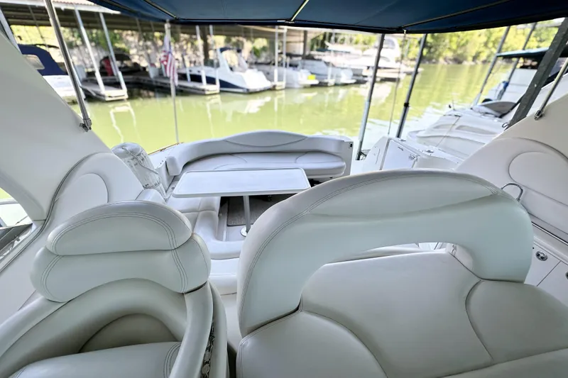 Slide: The Image of Interior view of 2001 Sea Ray 410 Sundancer yacht with white seating and table. - 9