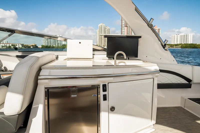 Slide: The Image of Luxurious 2019 Regal 33 OBX boat interior with kitchenette and scenic waterfront view. - 11