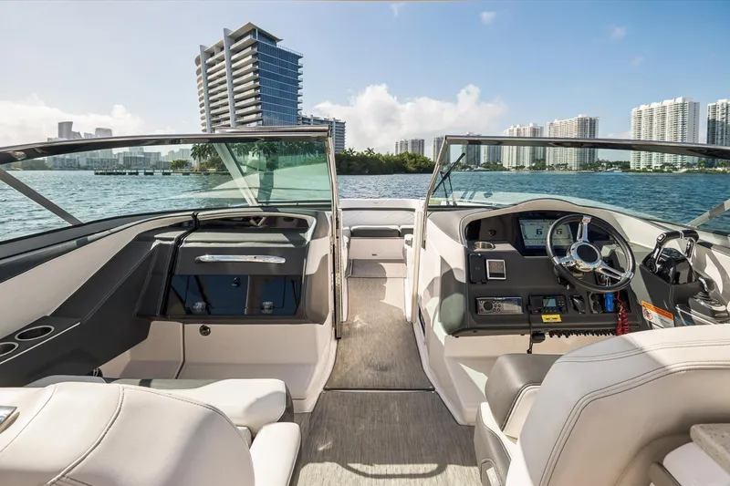 Slide: The Image of 2019 Regal 33 OBX boat interior with city skyline and waterfront view. - 13