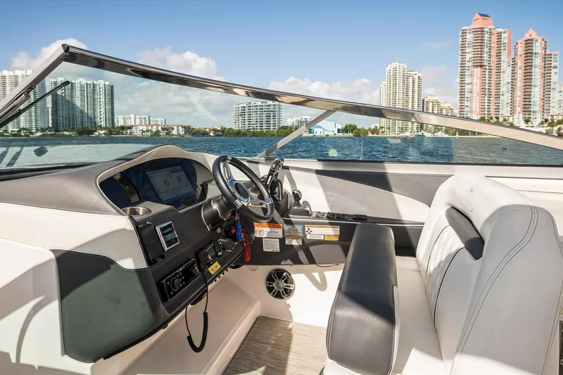 Slide: The Image of 2019 Regal 33 OBX boat interior with city skyline in the background. - 14