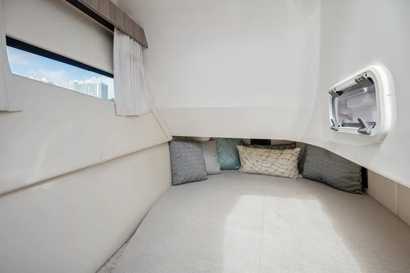 Slide: The Image of Cozy interior cabin of 2019 Regal 33 OBX boat with cushions and window. - 22
