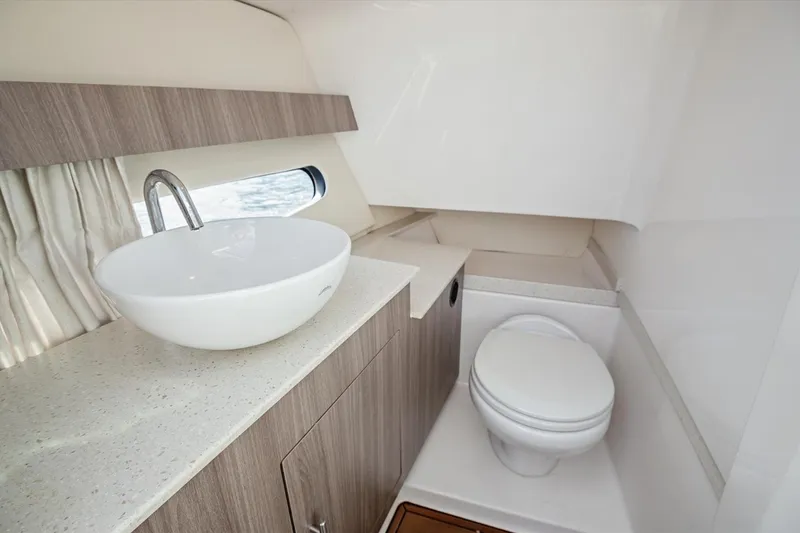 Slide: The Image of Luxurious bathroom interior of 2019 Regal 33 OBX yacht with modern sink and toilet. - 23