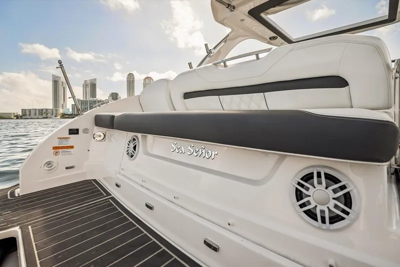 Slide: The Image of 2019 Regal 33 OBX boat with luxury seating, city skyline in background. - 24