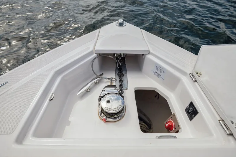 Slide: The Image of Bow anchor compartment of 2019 Regal 33 OBX boat with chain and winch. - 26