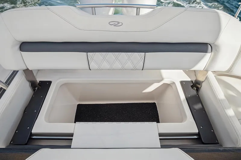 Slide: The Image of 2019 Regal 33 OBX boat storage compartment with cushioned seating and elegant design. - 27