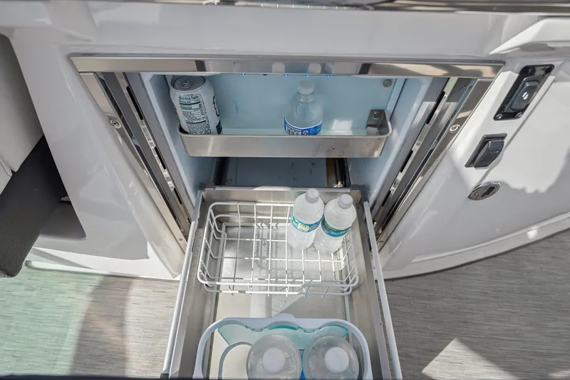 Slide: The Image of Built-in refrigerator on 2019 Regal 33 OBX boat with drinks stored inside. - 29