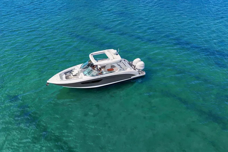 Slide: The Image of 2019 Regal 33 OBX boat floating on clear turquoise water. - 3