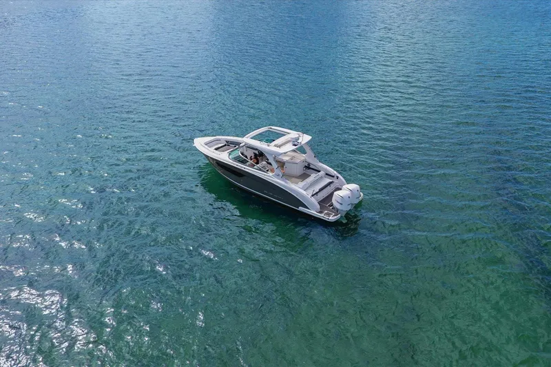 Slide: The Image of 2019 Regal 33 OBX boat cruising on clear blue water. - 4