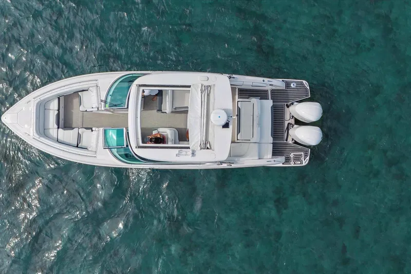 Slide: The Image of Overhead view of 2019 Regal 33 OBX boat on clear blue water. - 5