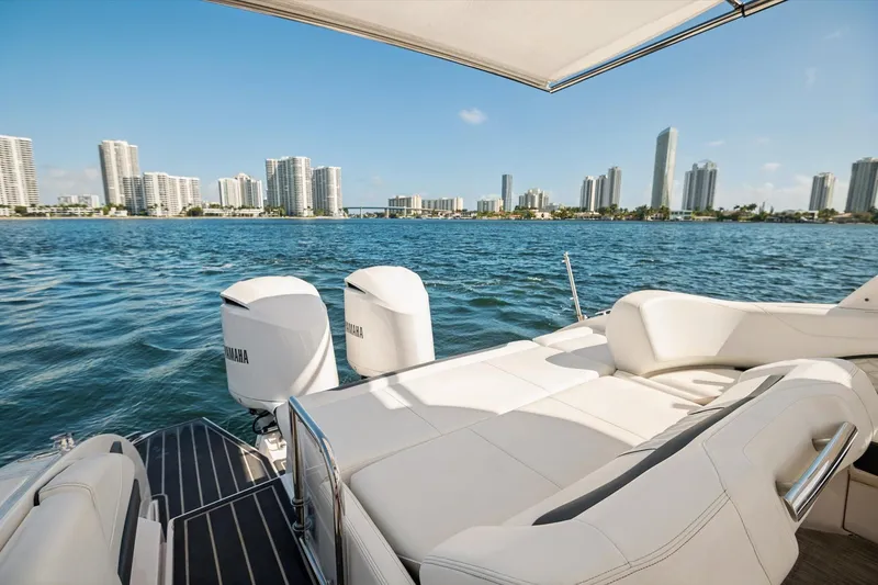 Slide: The Image of 2019 Regal 33 OBX boat with Yamaha engines, city skyline in background. - 9