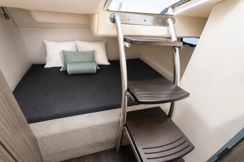 Slide: The Image of Cozy cabin interior of 2019 Regal 26 XO boat with ladder and bedding. - 11