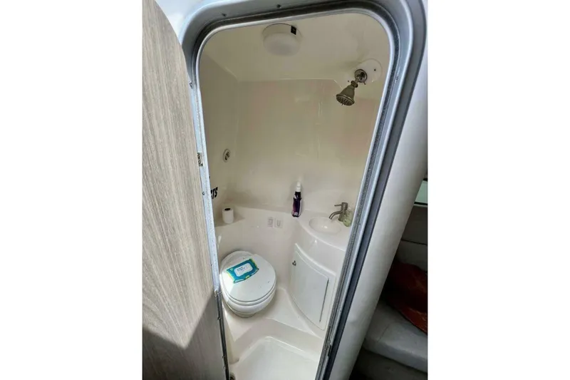 Slide: The Image of 2019 Regal 26 XO boat bathroom with shower, toilet, and sink. - 12