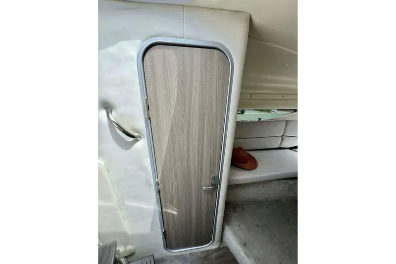 Slide: The Image of Interior cabin door of 2019 Regal 26 XO boat, featuring sleek design and cozy seating. - 13