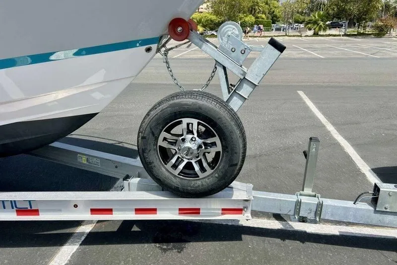 Slide: The Image of 2019 Regal 26 XO boat on trailer with wheel in parking lot. - 16